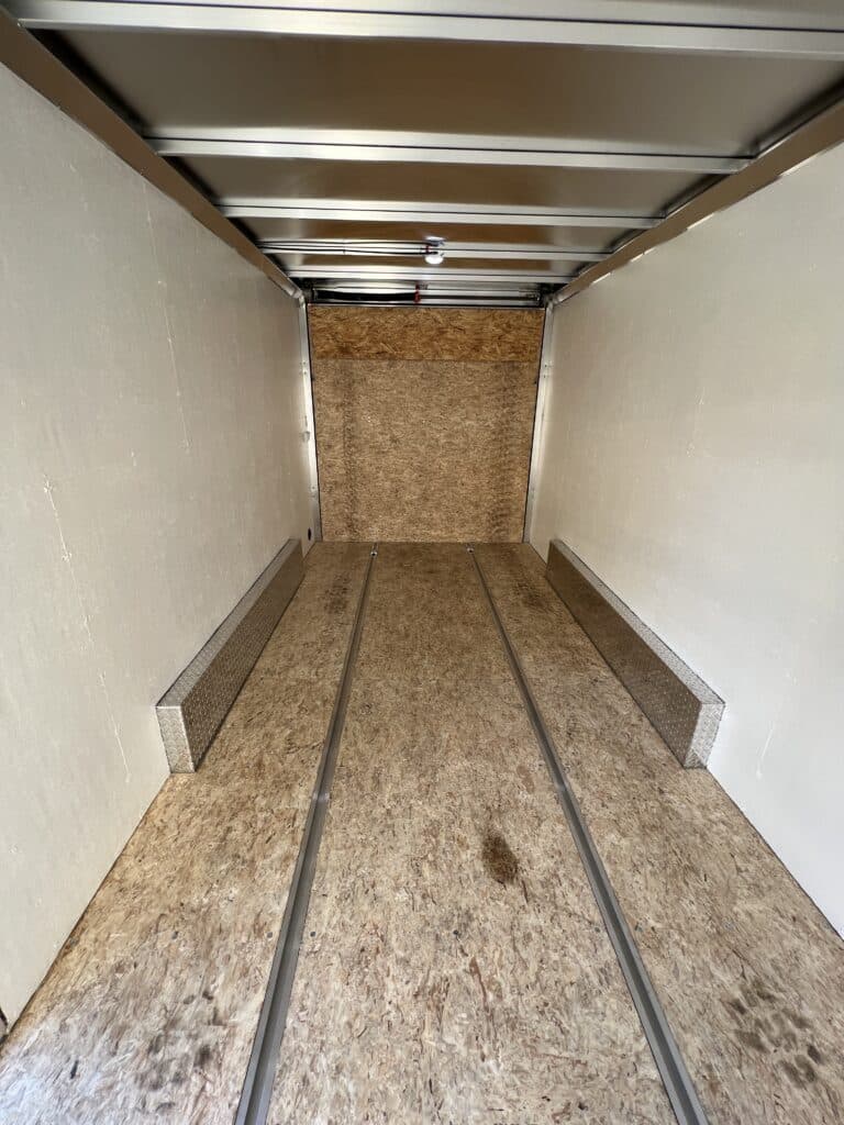 Inside of dirt bike trailer with walls painted but the floor raw wood