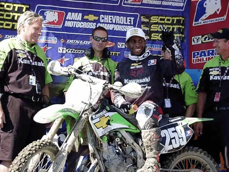 james stewart with his team on podium after winning championship