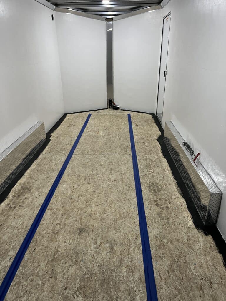 Interior floor of enclosed trailer being painted