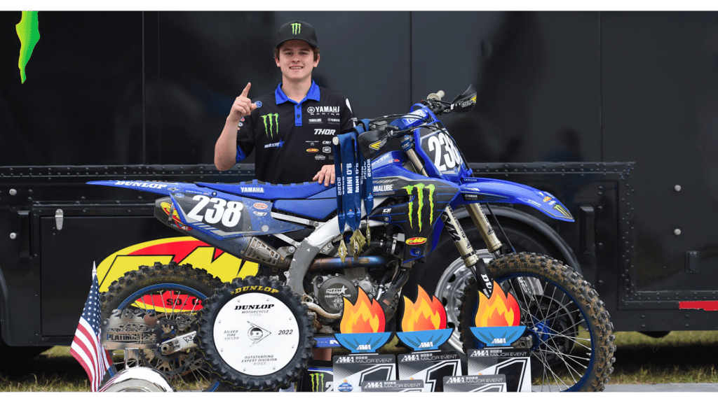 Haiden Deegan standing behind his YZ250F with Mini O's trophies in front